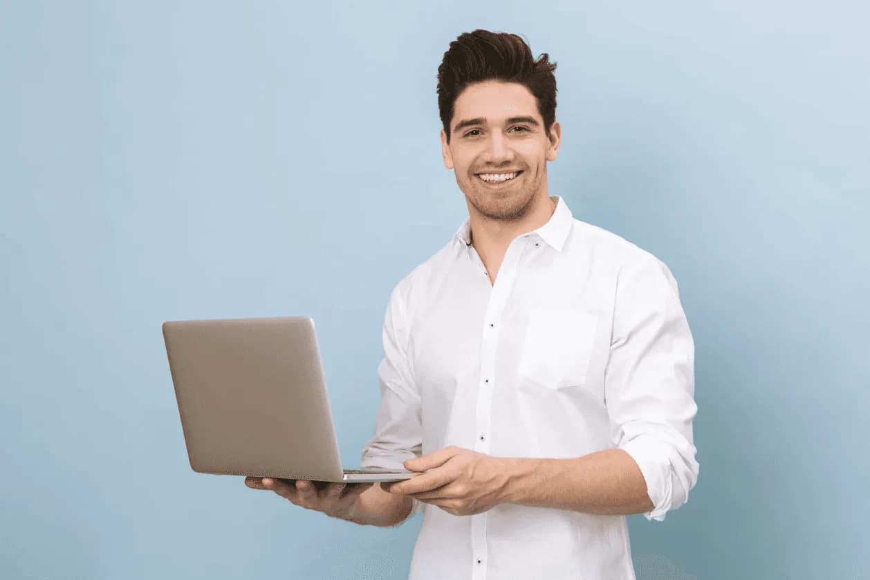 Professional analyst smiling while reviewing Amazon ad attribution data on a laptop