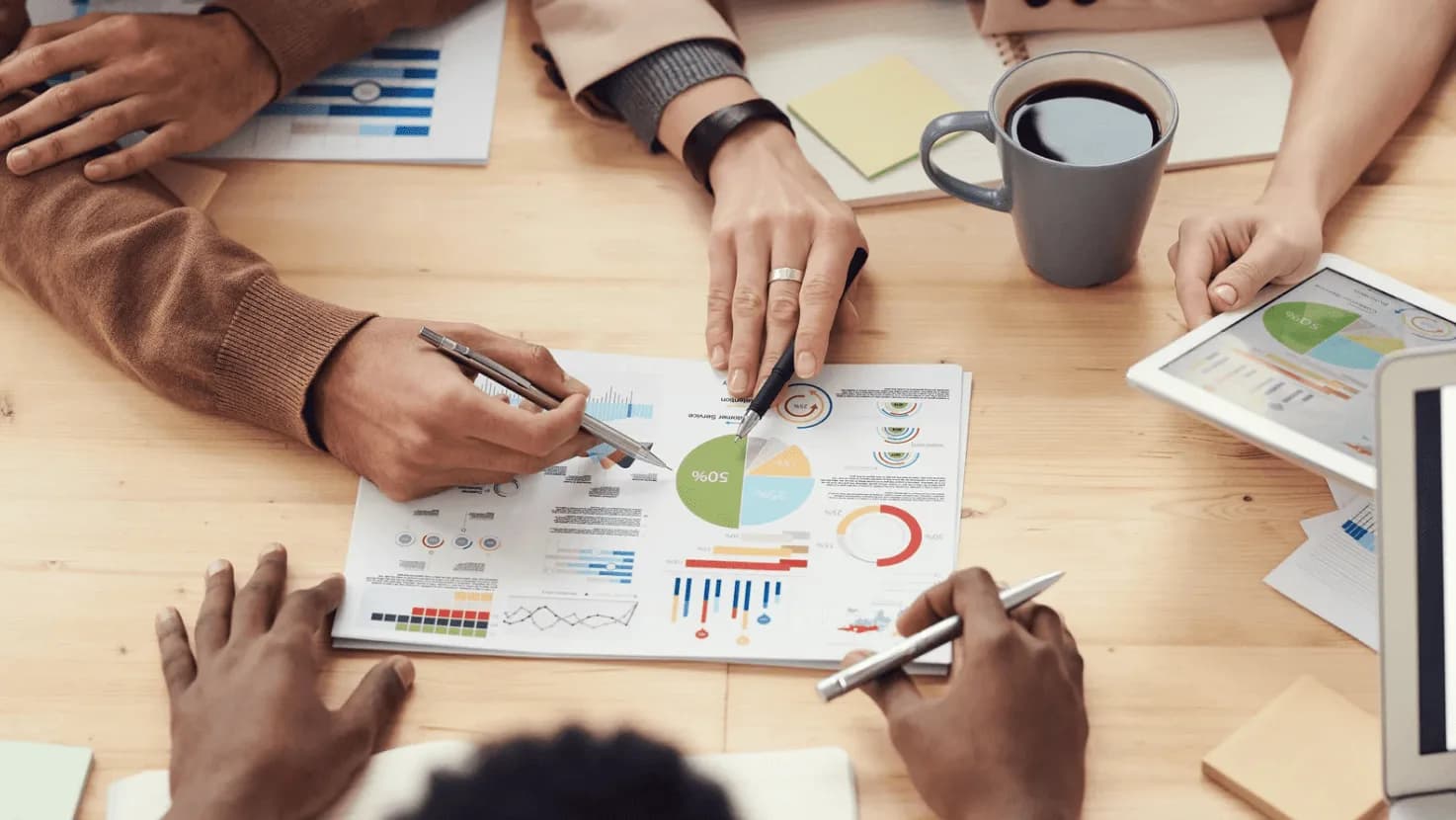 Team collaborating over data charts and analytics, highlighting how Autron empowers Amazon sellers to focus on high-level strategy and growth.