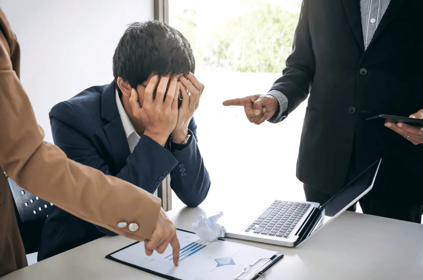 Team reviewing performance charts, showing how Amazon Ads portfolio budget caps can force top campaigns to pause and fuel conflict