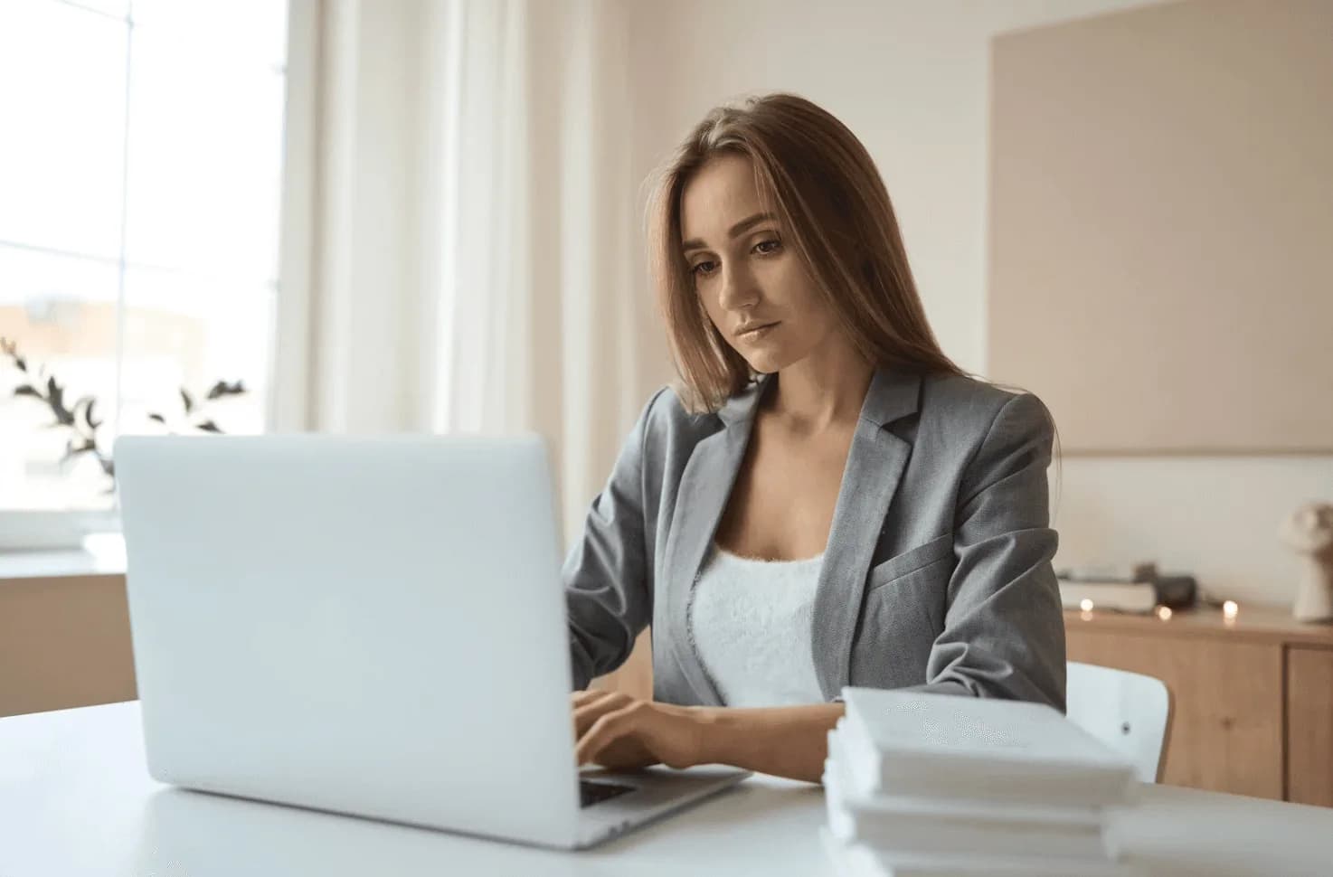 Marketer analysing Amazon Ads search terms on a laptop to spot internal cannibalisation between overlapping campaigns