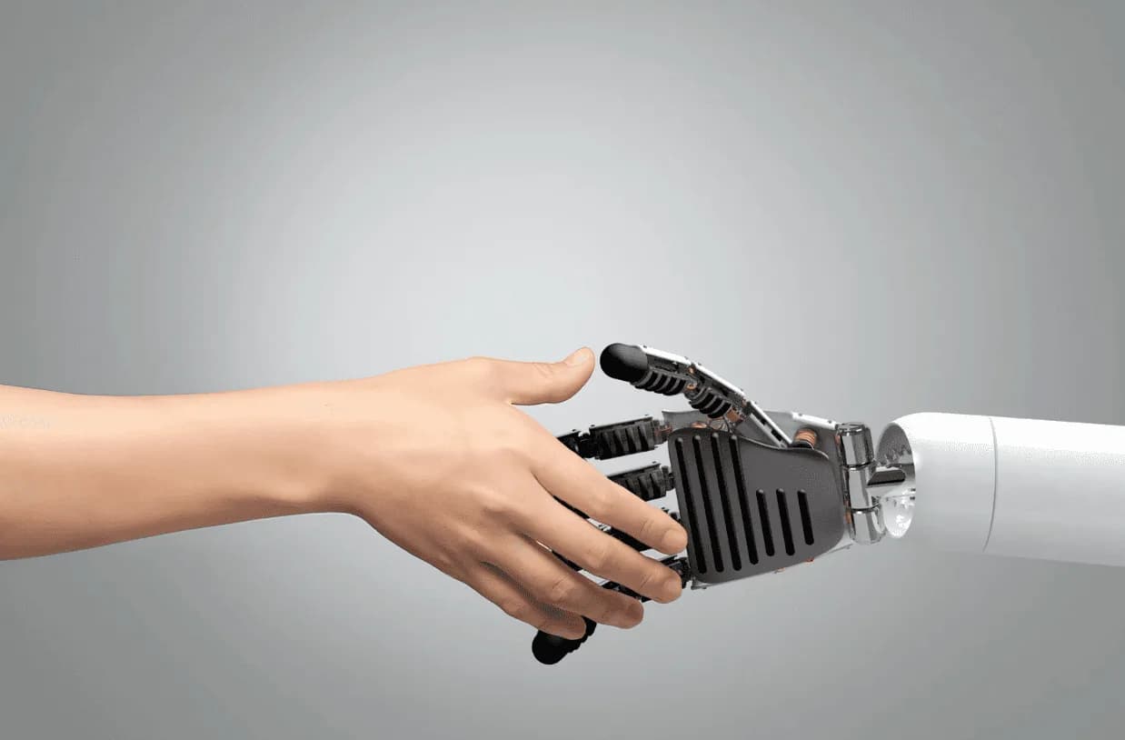 Human hand shaking robotic hand, representing AI collaboration and future technology integration