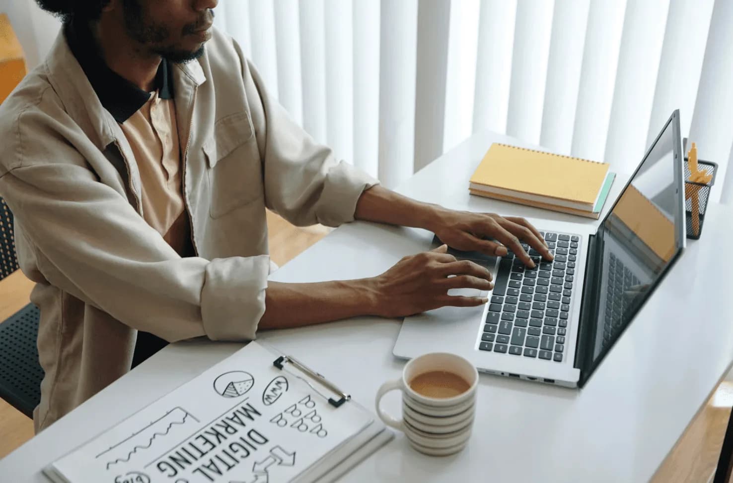 Amazon seller managing Q1 PPC campaigns on laptop with digital marketing strategy notes and ongoing optimization planning