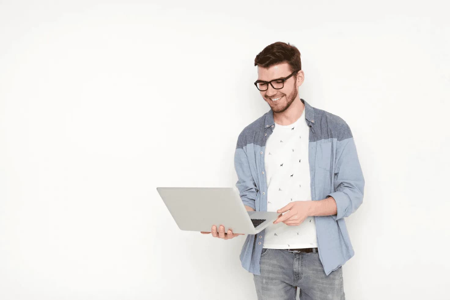 Man smiling while using a laptop, representing faster decision-making and automation advantages for high-volume Amazon sellers.