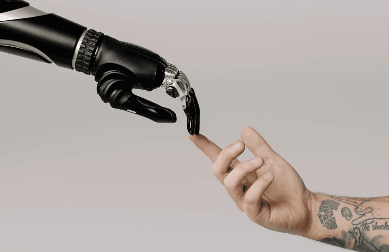 Human hand and robotic hand touching fingers, symbolising automation and technology in Amazon advertising strategy