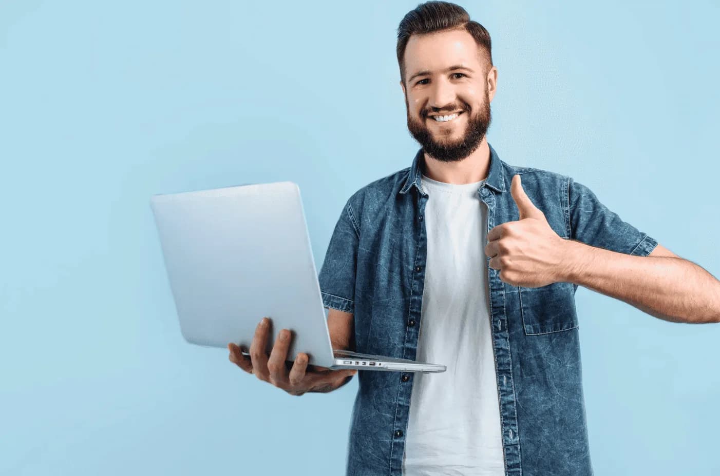 Smiling man holding laptop and giving thumbs up, representing initial ad success perception