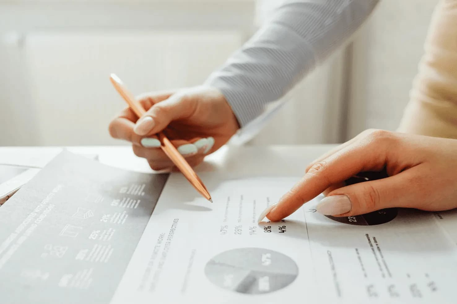Close-up of hands analyzing Amazon PPC performance data and metrics during Black Friday Cyber Monday
