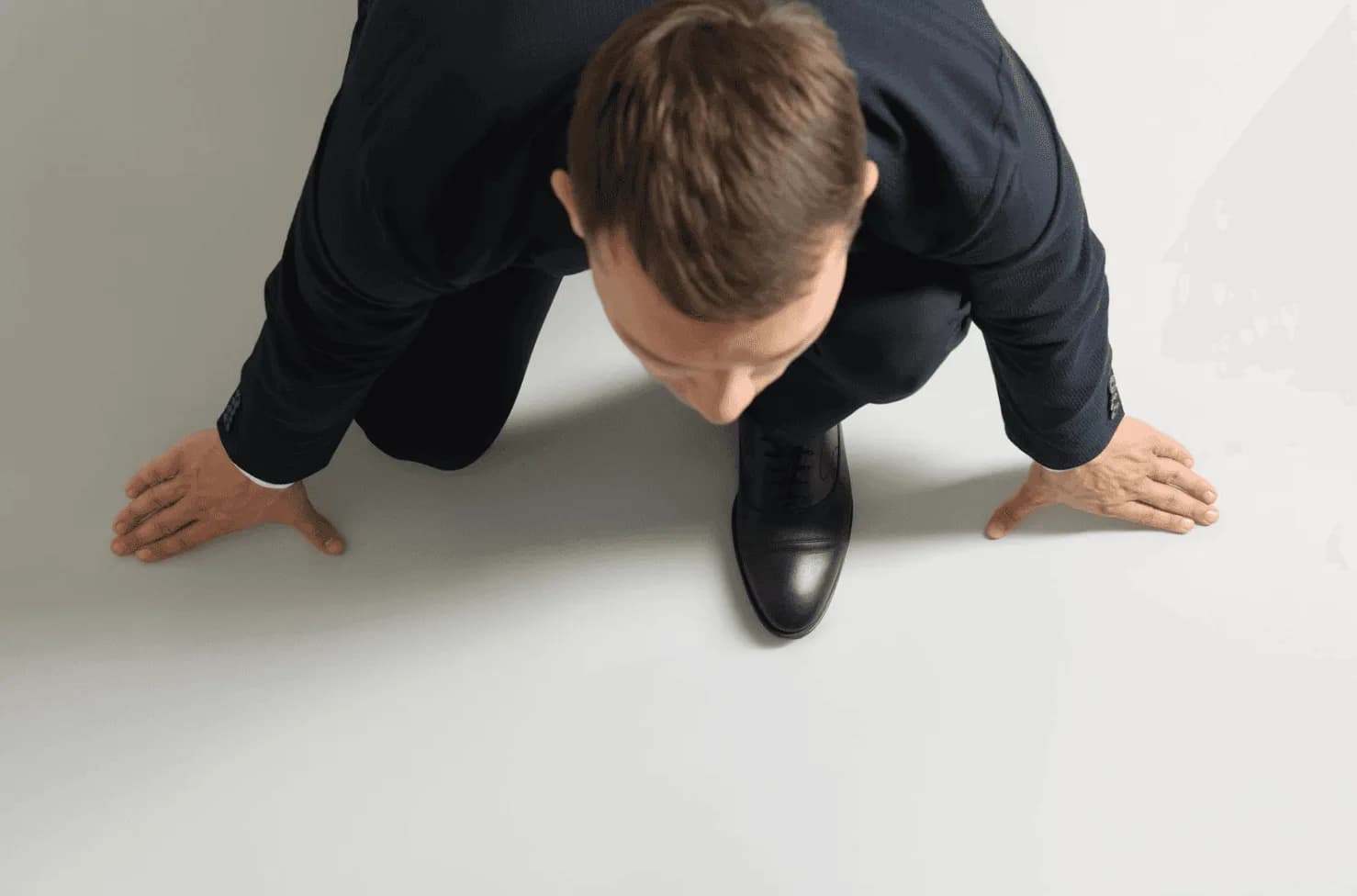 Businessperson crouched at a starting line — symbolising the race to keep up with real-time Amazon ad auction shifts.